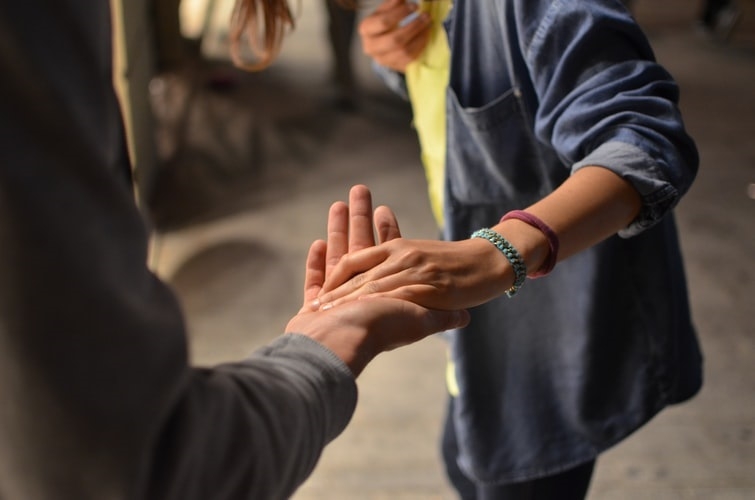 A young woman joining hands with a man