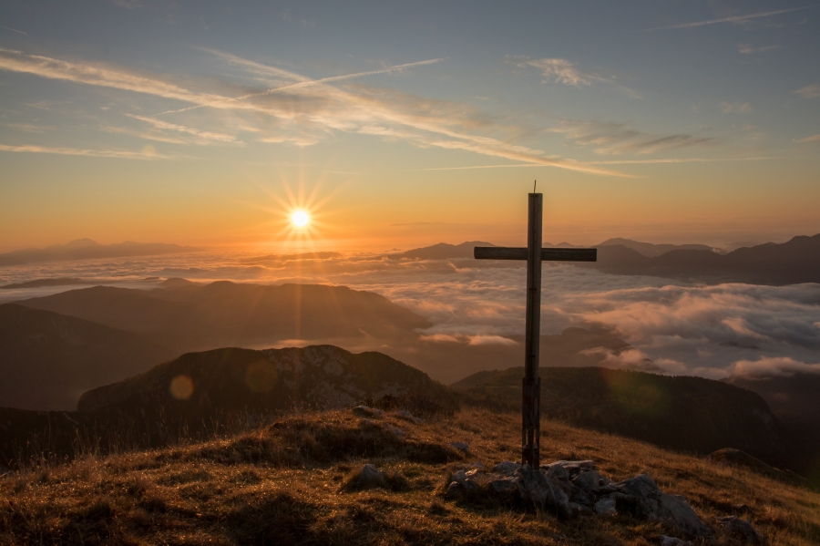 Large cross on a hill at sunrise