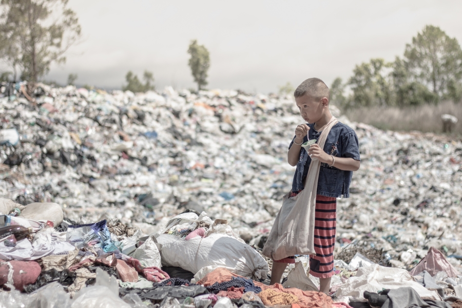 Child sorting through pile of rubbish