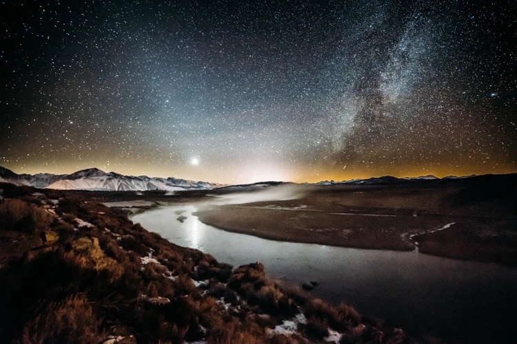 River flowing under a starry sky